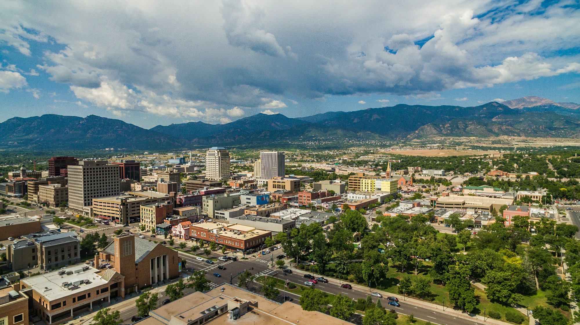 Aerial view of downtown Colorado Springs with Rocky Mountains